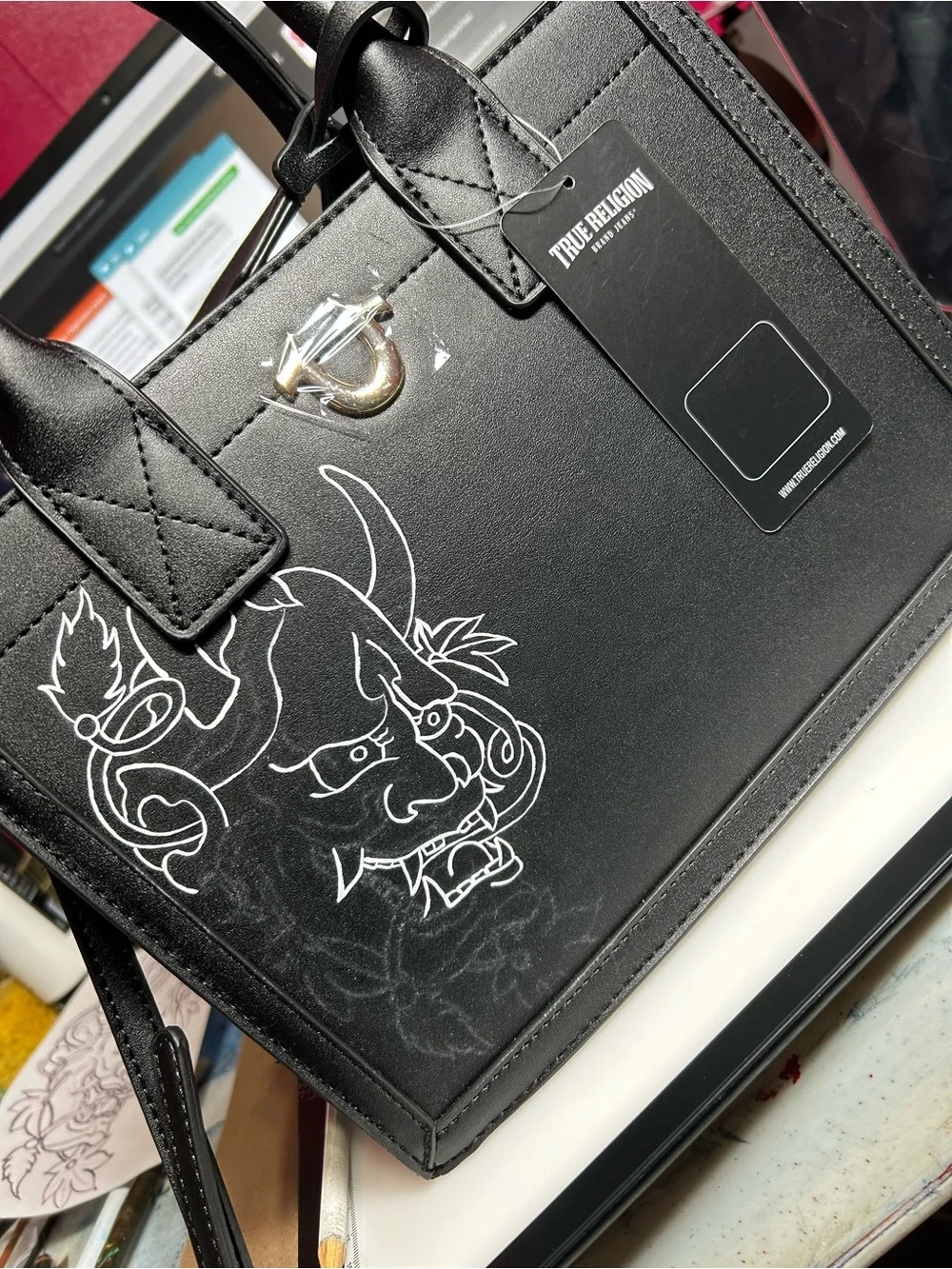 True Religion Black Satchel with White Graphic Demon Motif